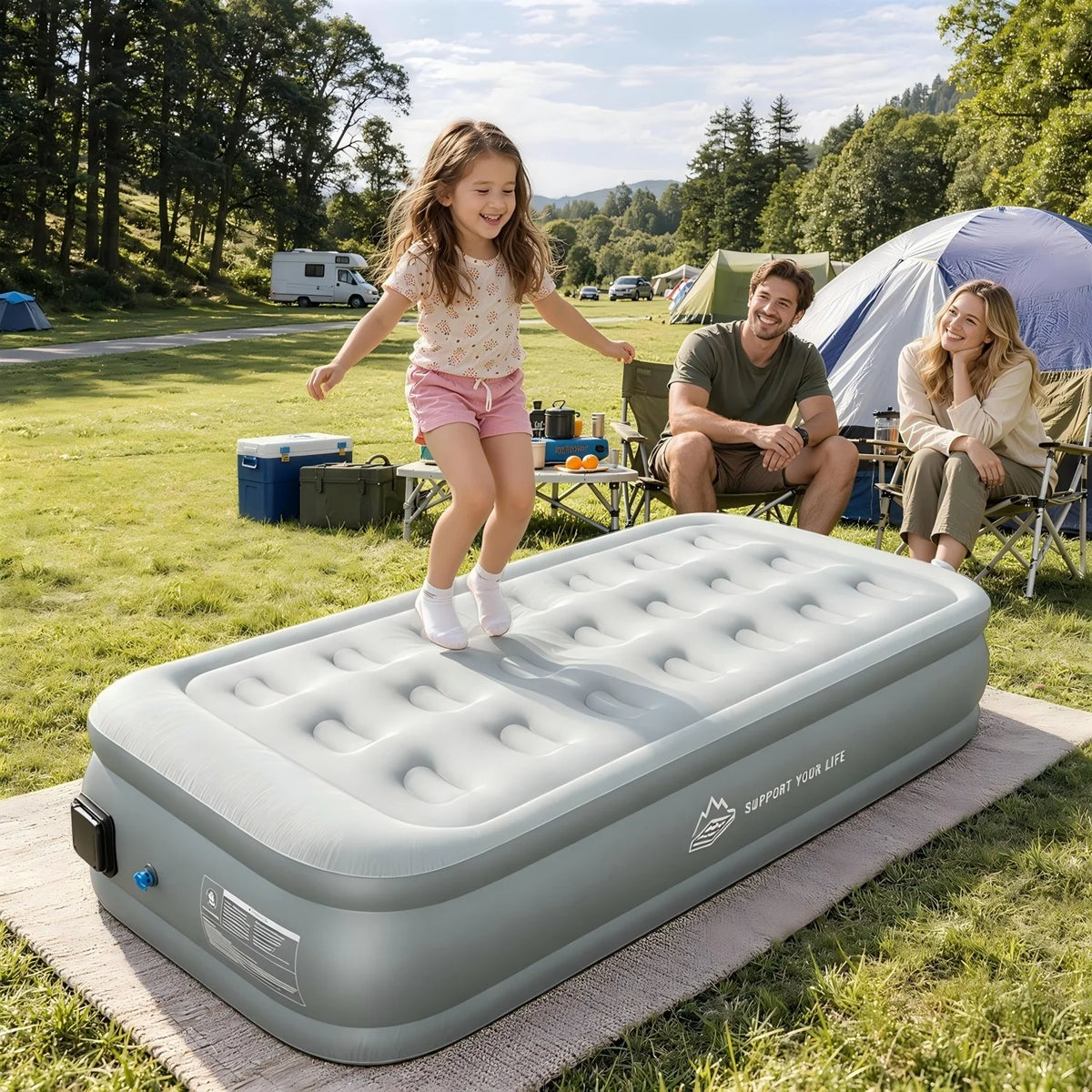 Family enjoying a JUITOY air mattress at a sunny outdoor campsite