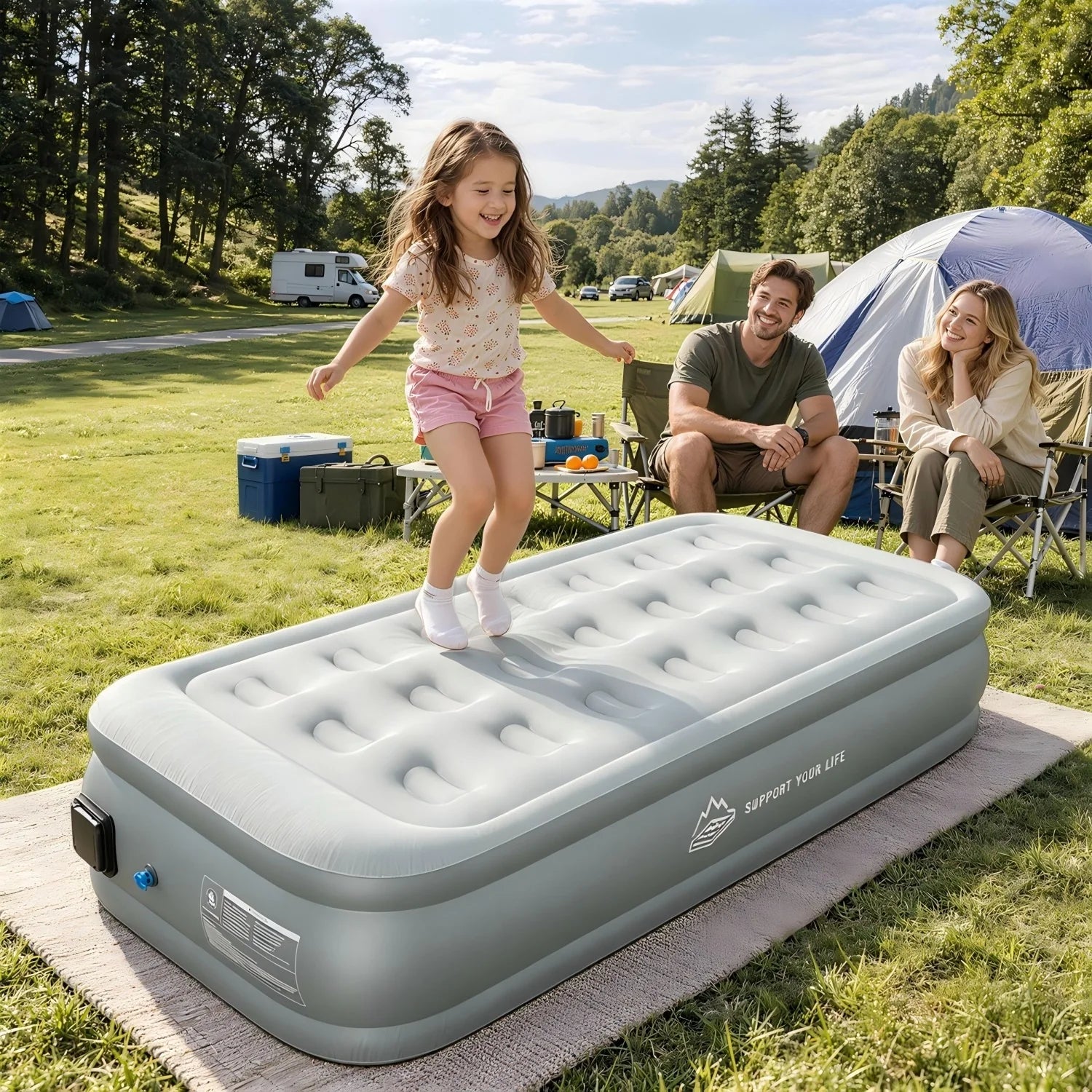 Family enjoying a JUITOY air mattress at a sunny outdoor campsite