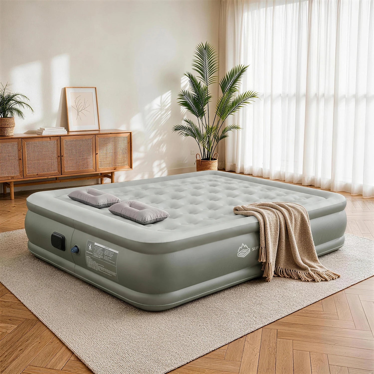 JUITOY Queen air mattress set up in a warm guest room